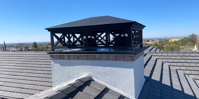 A decorative black steel multi-flue chimney shroud 