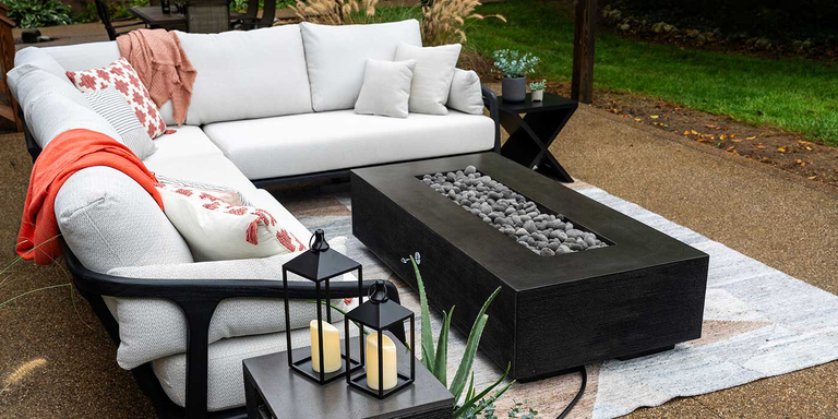 An outdoor patio space with a black FlameCraft Zen Gas Fire Pit 