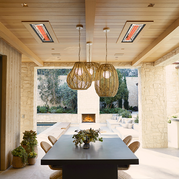 A semi-enclosed outdoor dining space with two Infratech WD Series patio heaters flush-mounted to the ceiling
