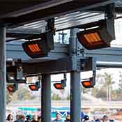Ceiling-mounted patio heaters installed in an outdoor restaurant area