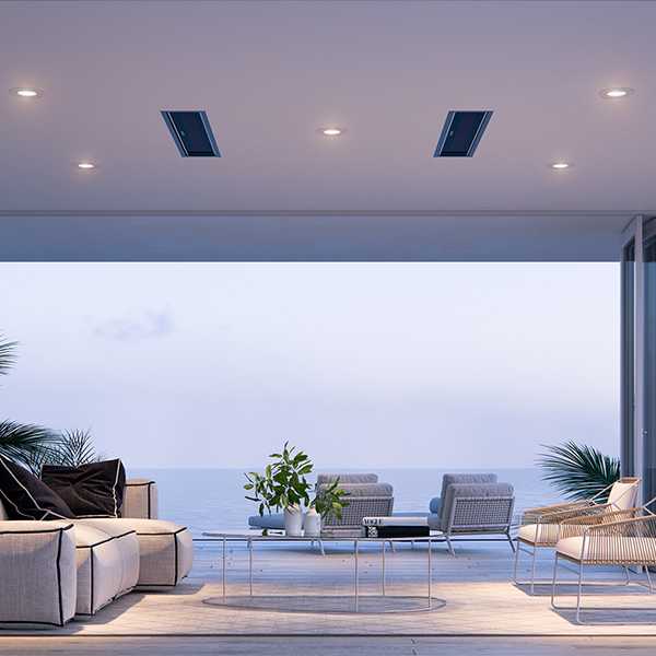 A semi-enclosed outdoor patio space with a lounge area and flush, ceiling-mounted Bromic Platinum Smart-Heat patio heaters.